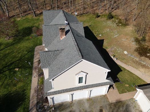 An aerial view of a large house with a gray roof.