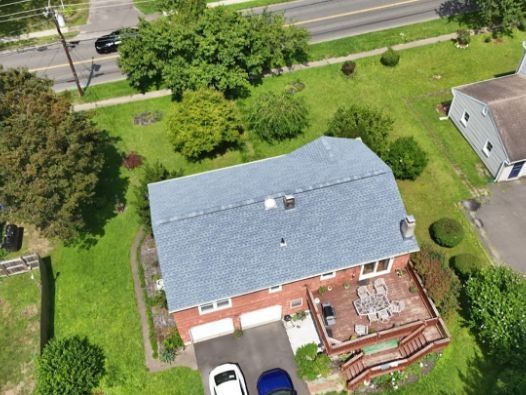 An aerial view of a house with a blue roof
