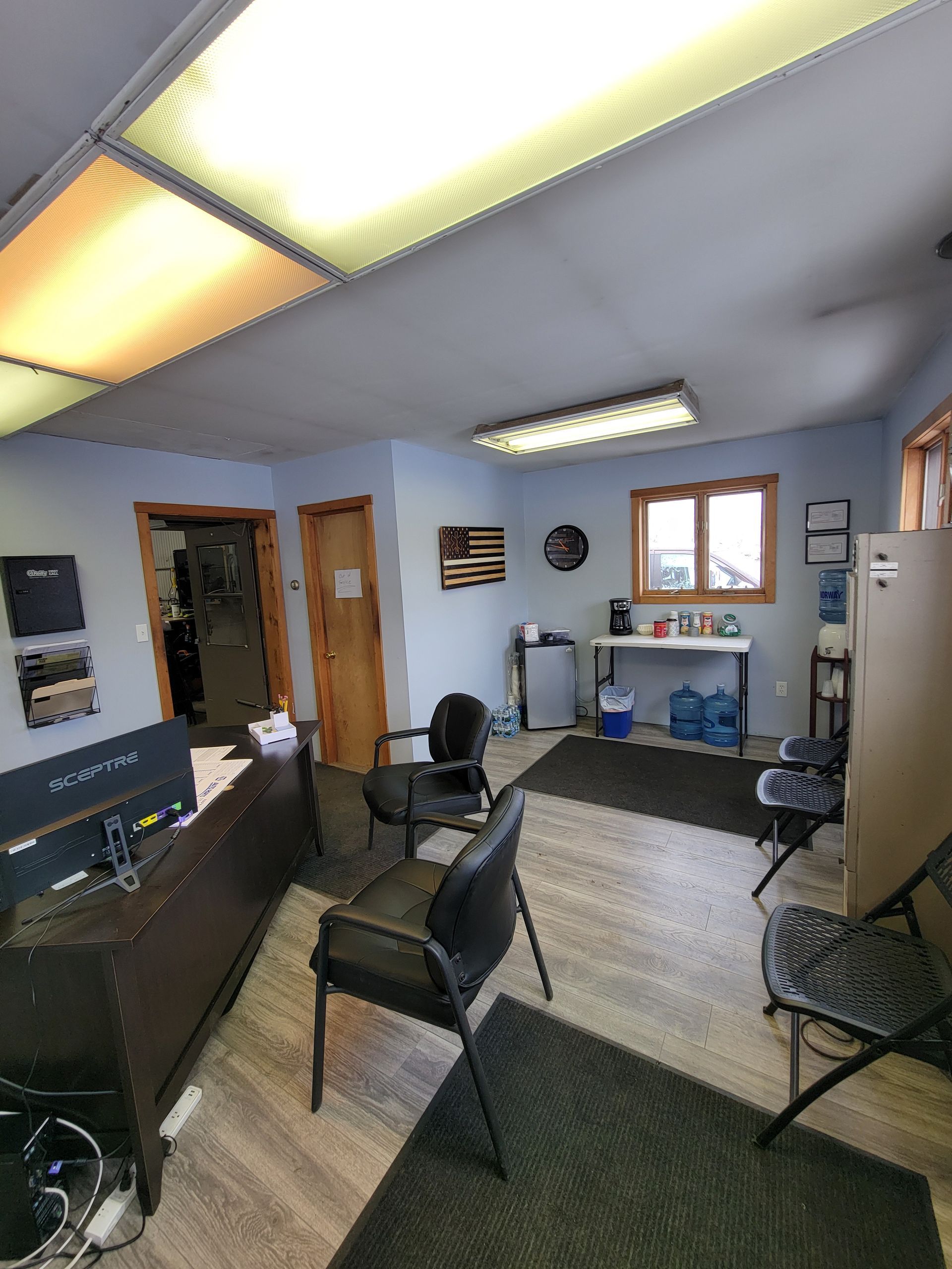 A room with a table , chairs , and a television.