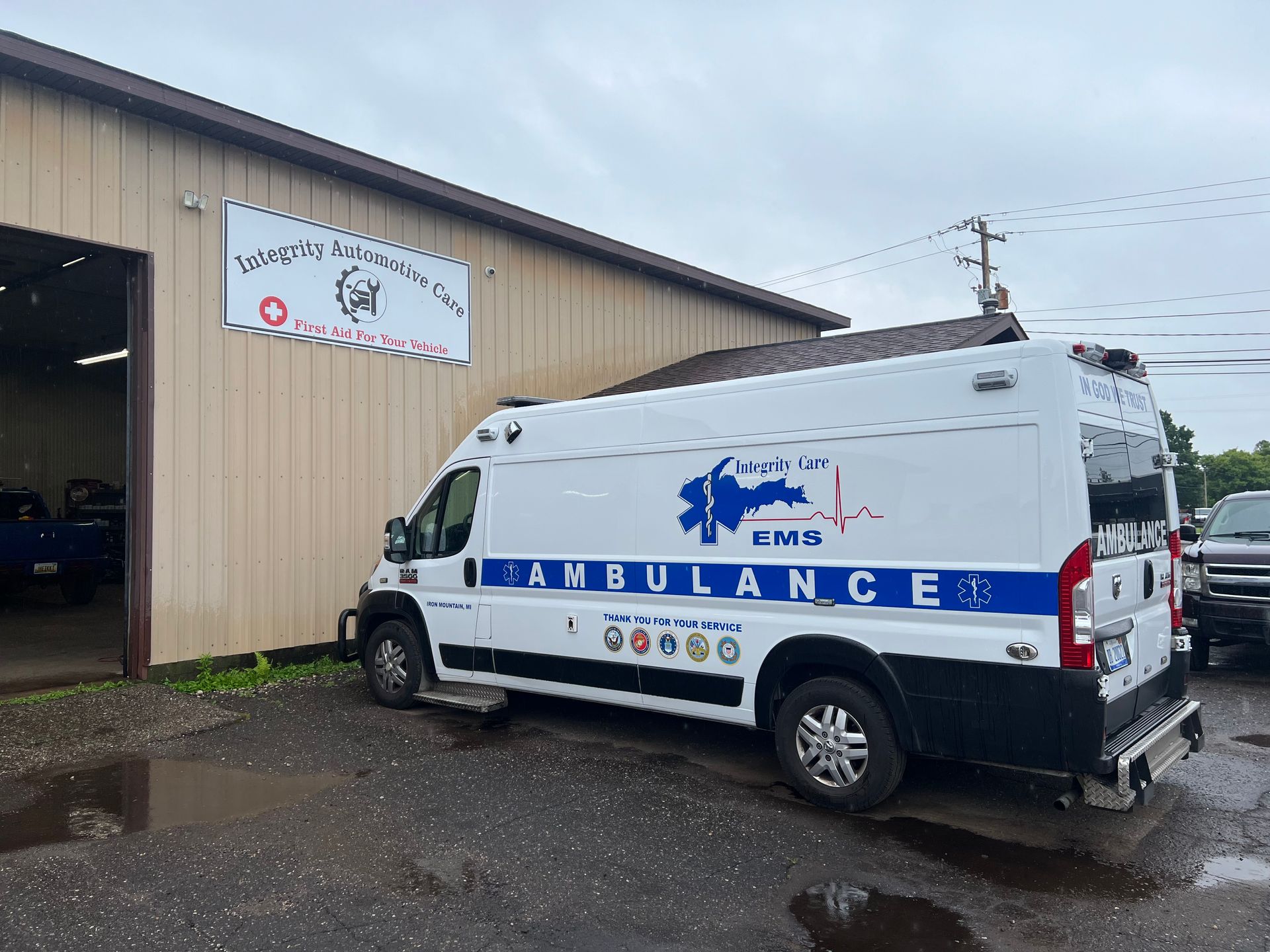 A white ambulance is parked in front of a building.