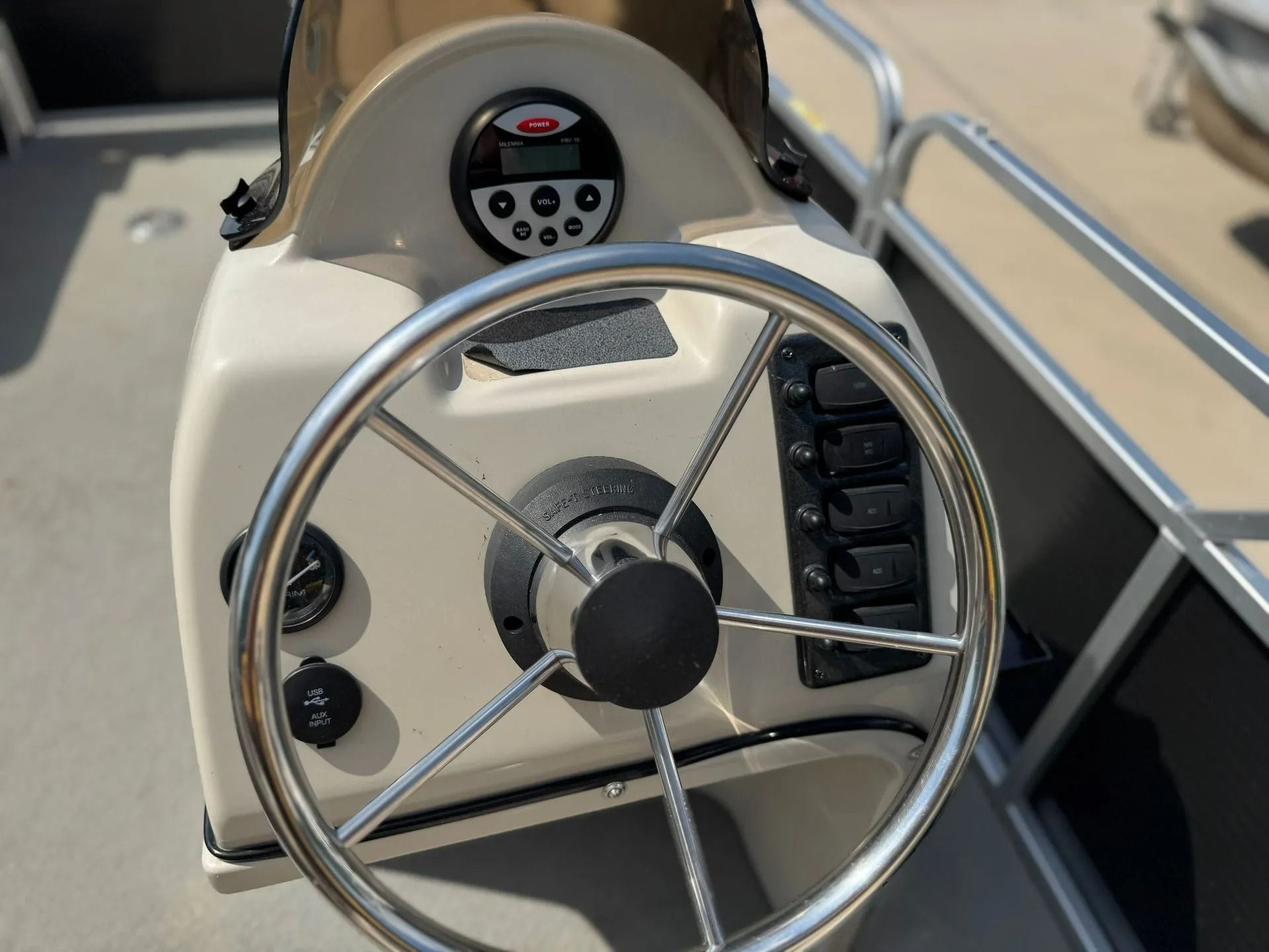 Boat helm with stainless steering wheel and instrument panel in beige cockpit