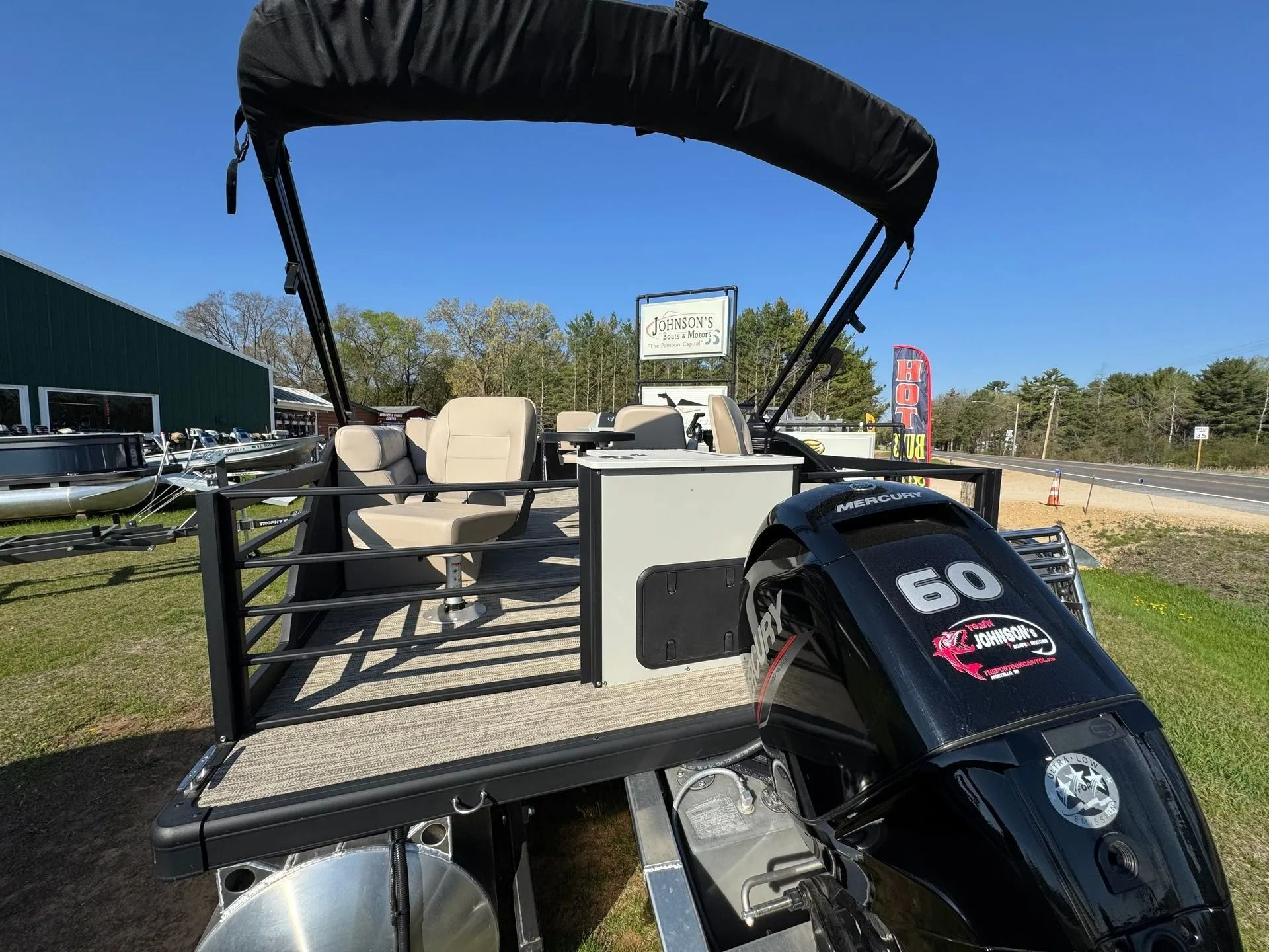 Golf cart on a sunny course with beige seats, black canopy, and a Yamaha motor in the foreground