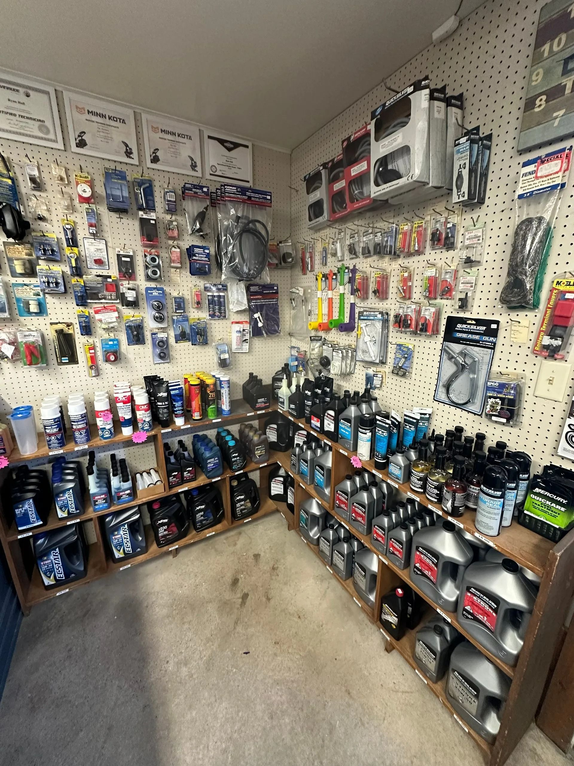 Pegboard wall of assorted packaged collectibles and accessories in a small retail room
