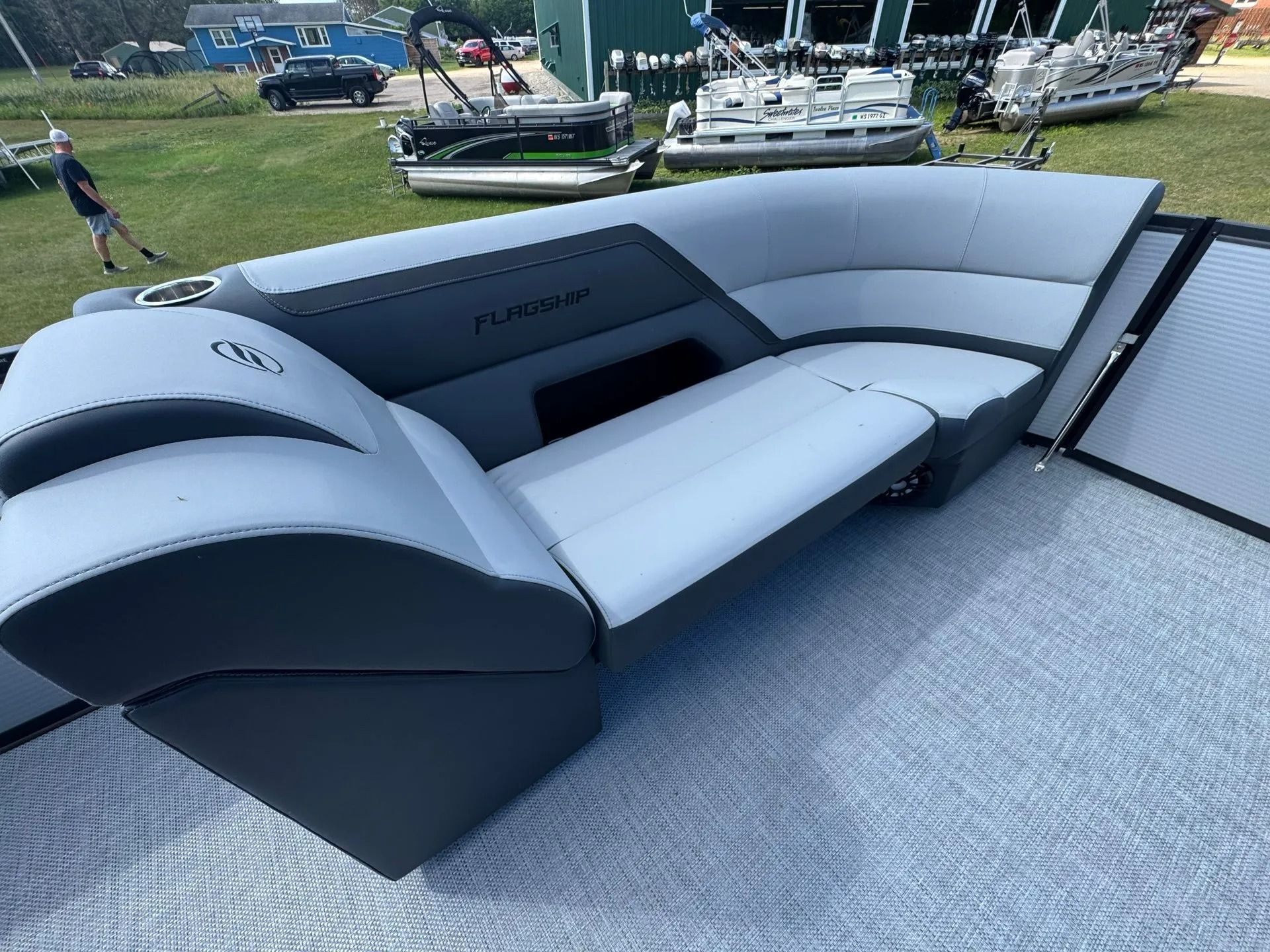 Curved gray-and-white boat seating on a deck at an outdoor marina display