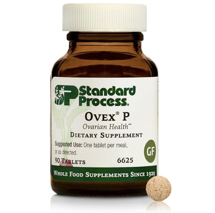 Bottle of Standard Process OVex P ovarian health dietary supplement with beige tablet beside it.