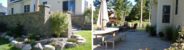 Exterior view of a house with a stone wall and patio with table, chairs, and umbrella.