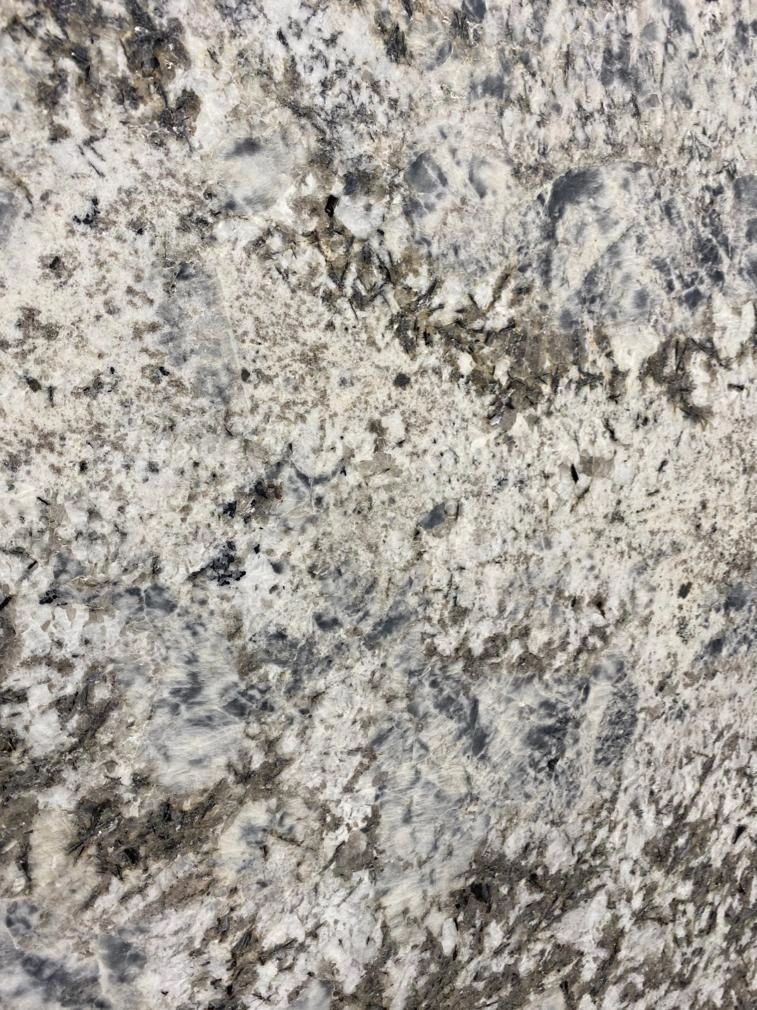 A close up of a white granite counter top.