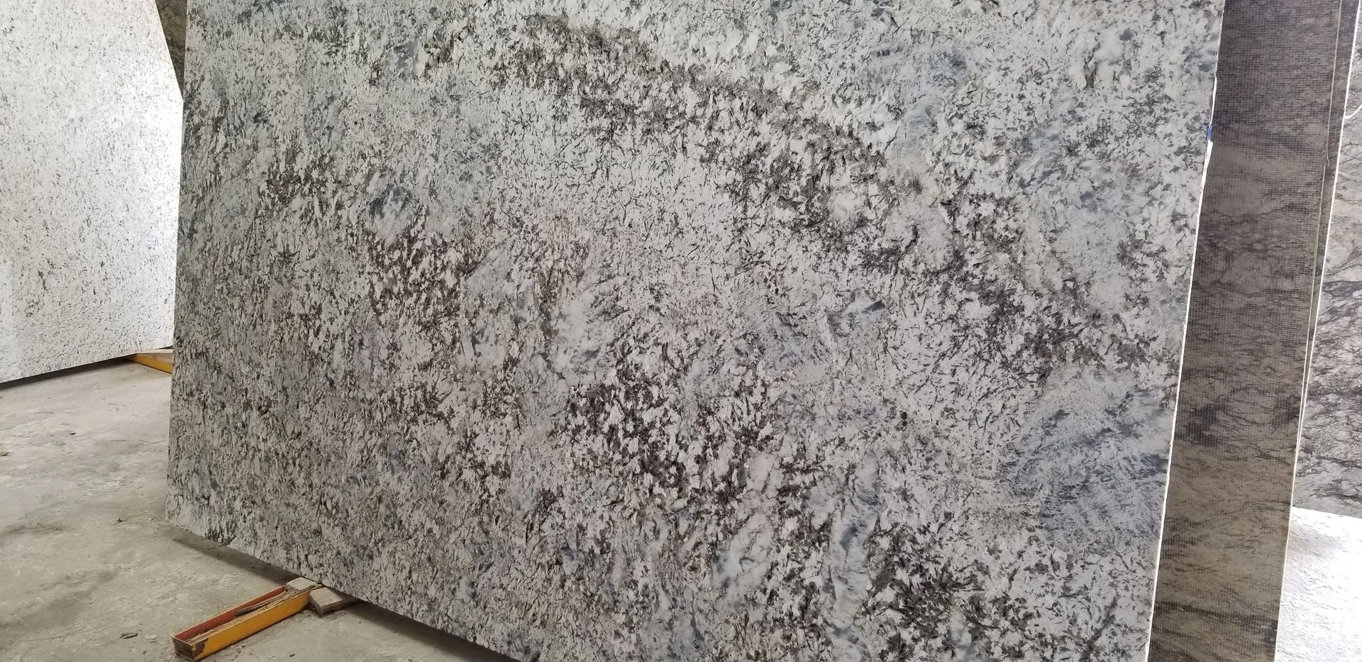 A close up of a granite slab sitting on top of a concrete floor.