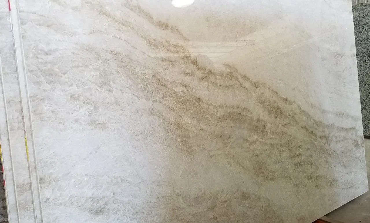 A white marble slab is sitting on top of a wooden table.