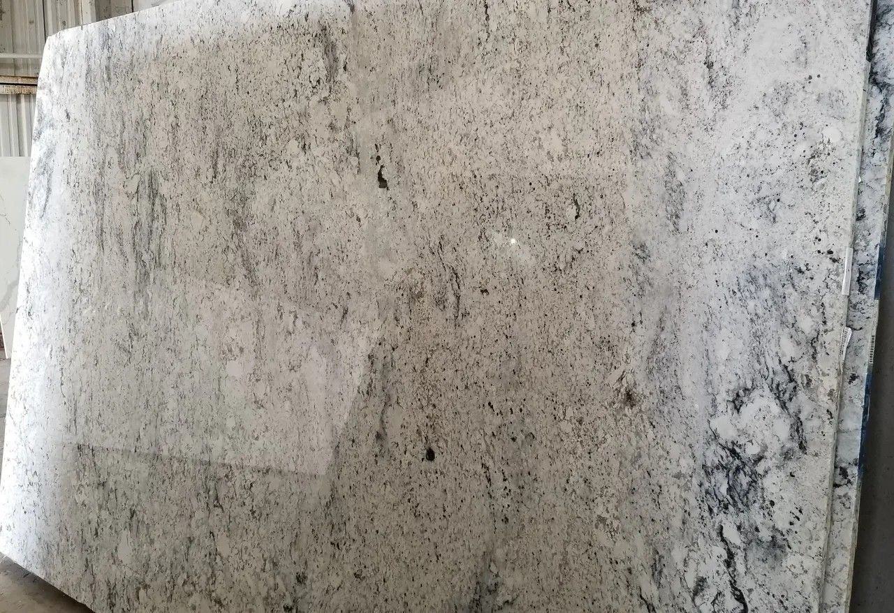 A large white granite slab is sitting on top of a table.