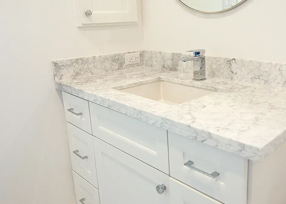 A bathroom vanity with a sink and a mirror.