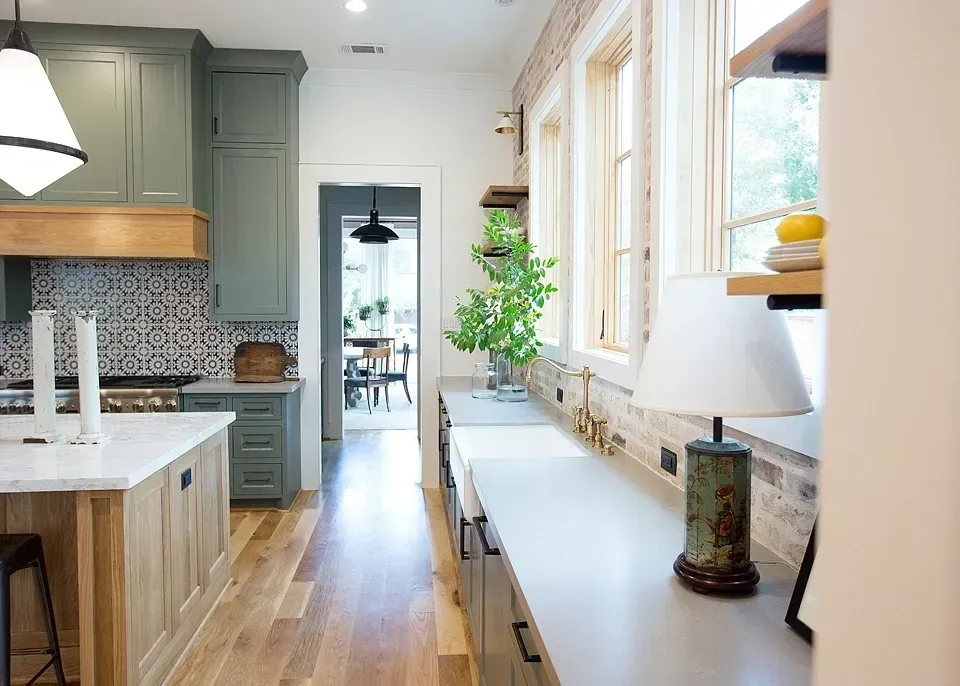 A kitchen with a sink and a lamp on the counter