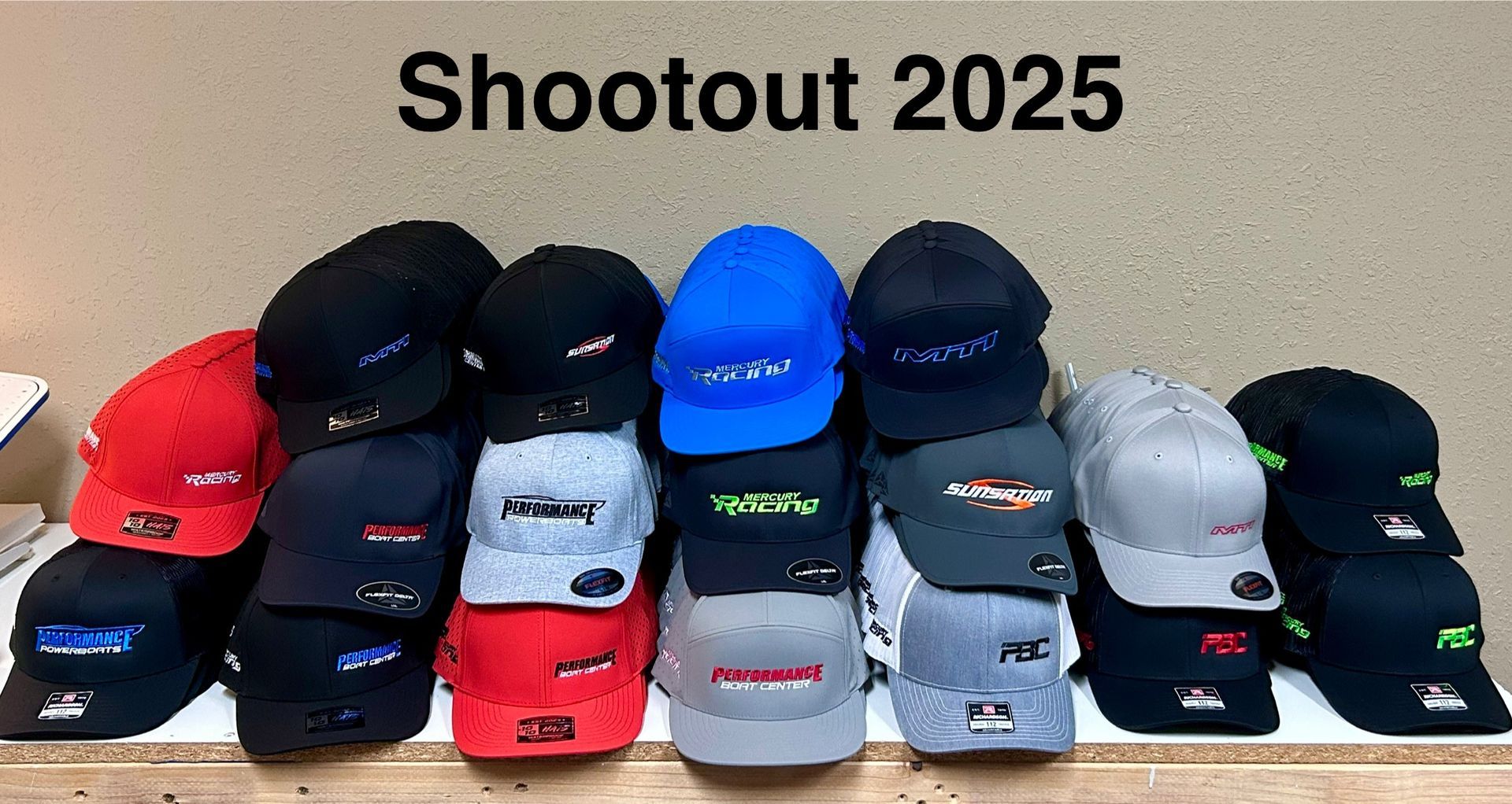 A pile of assorted baseball caps in various colors, promoting