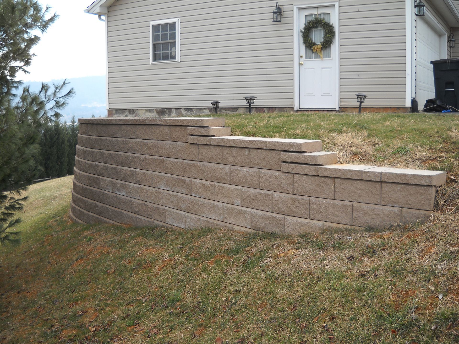 A house with a brick wall in front of it