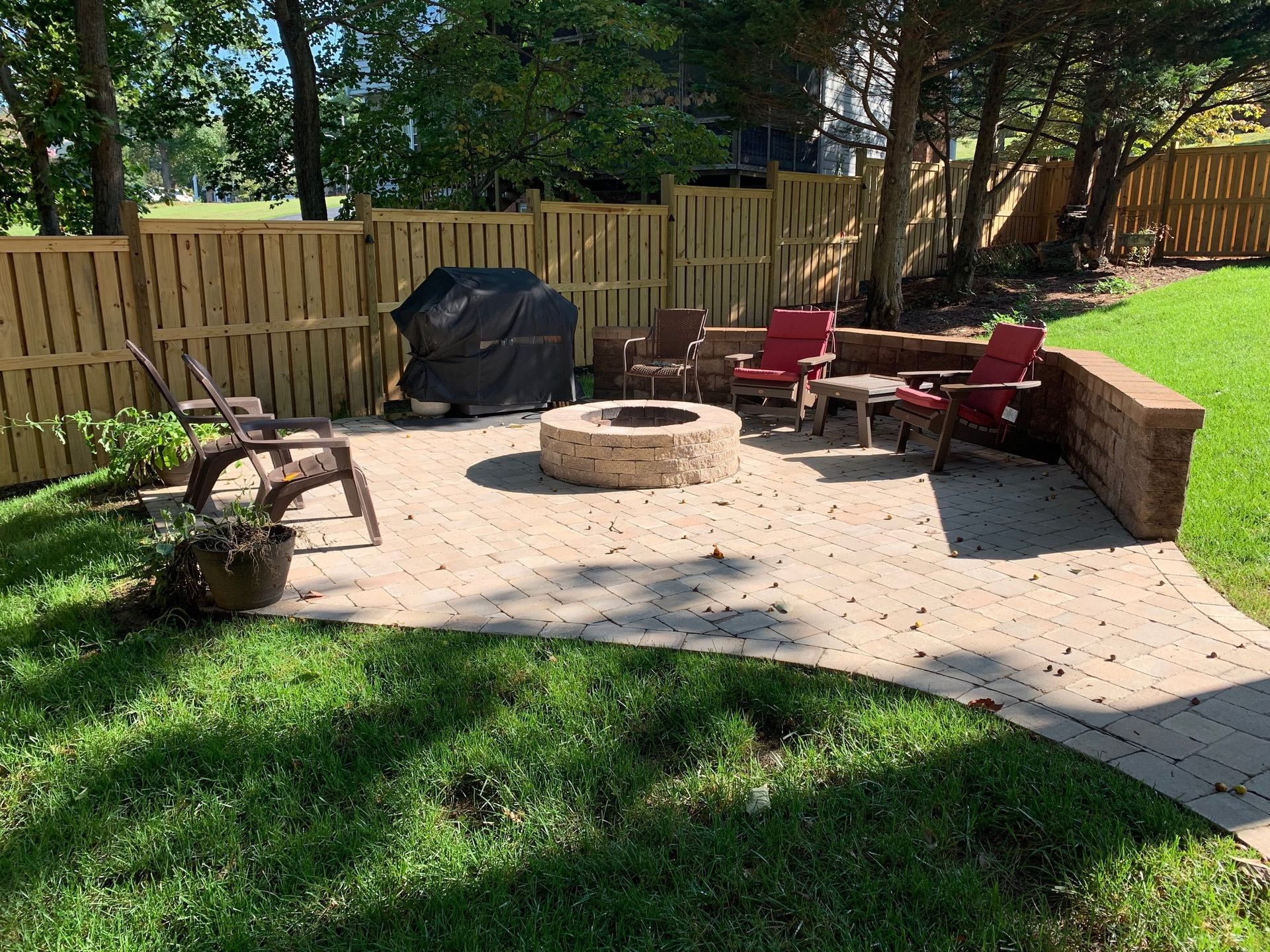 There is a fire pit in the middle of the backyard.