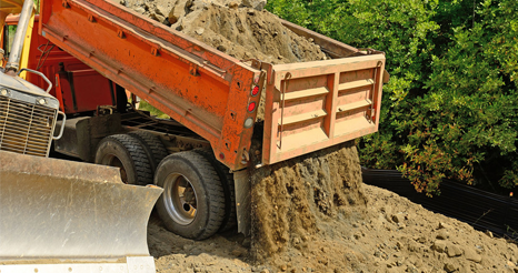 dump trucks with rock and soil