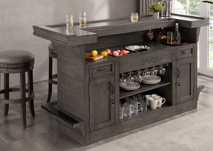 Gray wooden home bar with bar stools, glasses, and bottles.