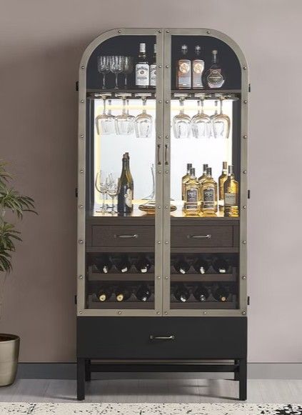 Bar cabinet with wine and liquor storage, lit interior, glass doors, and dark frame.