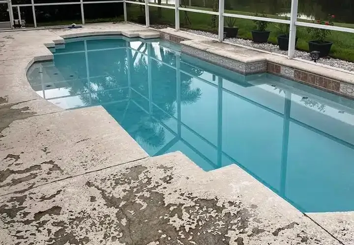 A large swimming pool with a fence around it