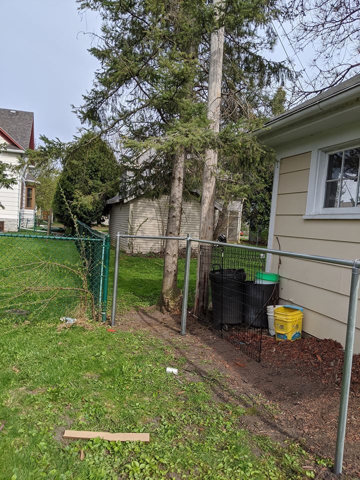A house with a chain link fence in front of it.