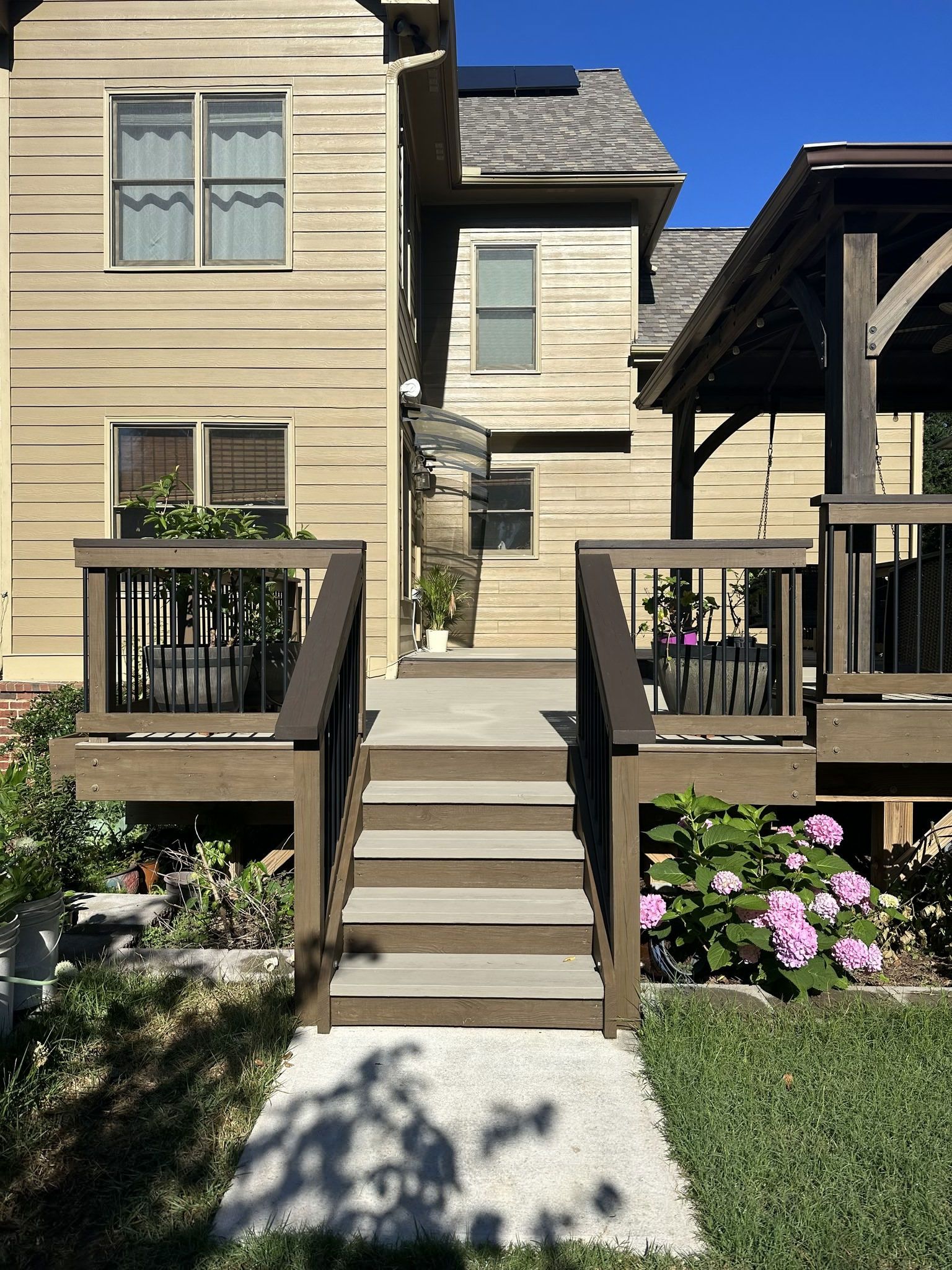 A house with a deck and stairs leading up to it.
