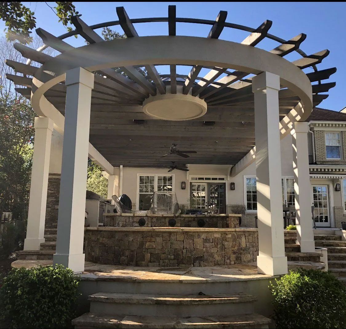 A house with a pergola and stairs in front of it