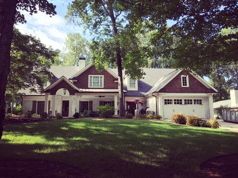 A large house with a large lawn in front of it