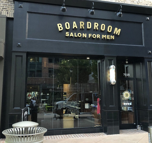 The boardroom salon for men is located on a brick building