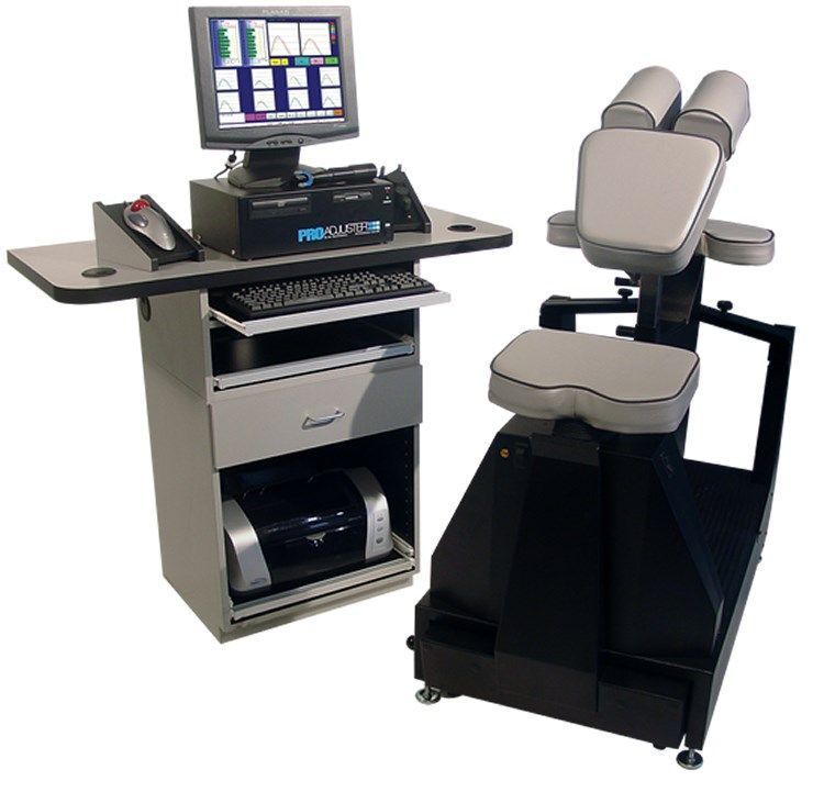Chiropractic examination system: a computer station with a connected adjustable examination chair.