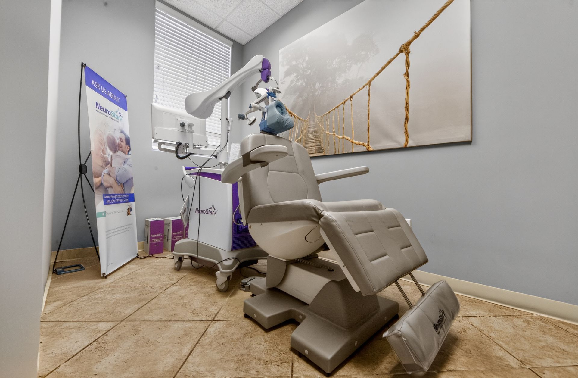 Dentist chair in a modern clinic room with gray walls and dental equipment nearby
