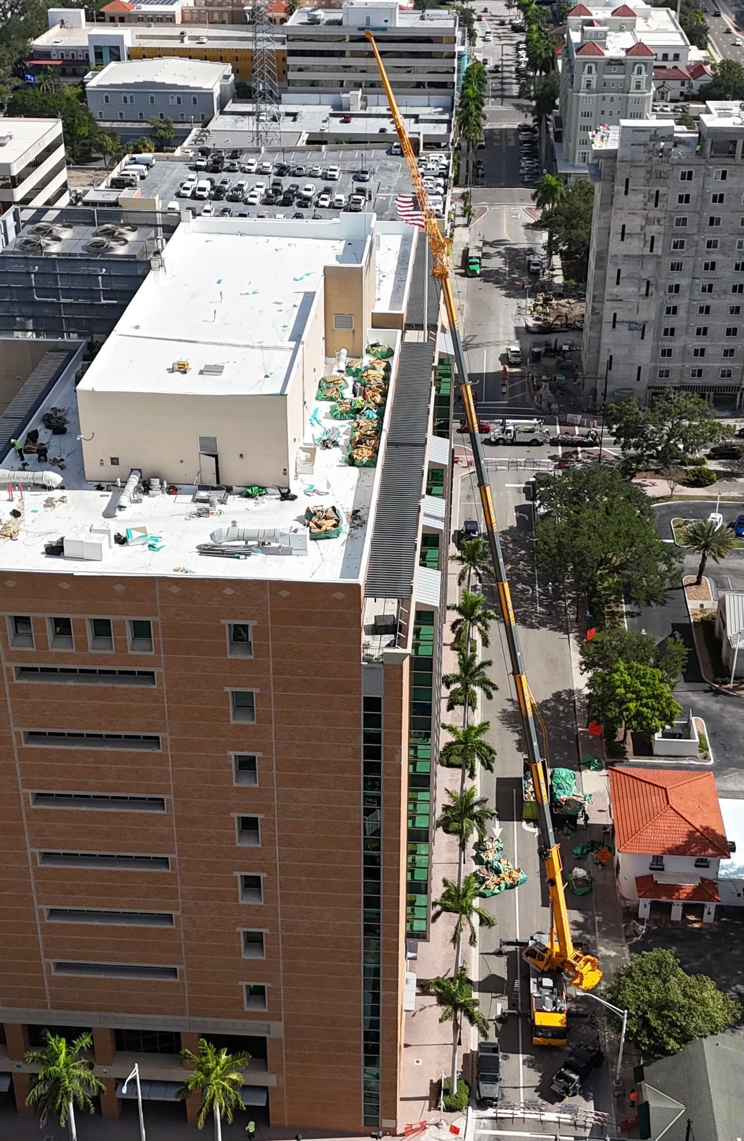 An aerial view of a city with a large building in the middle