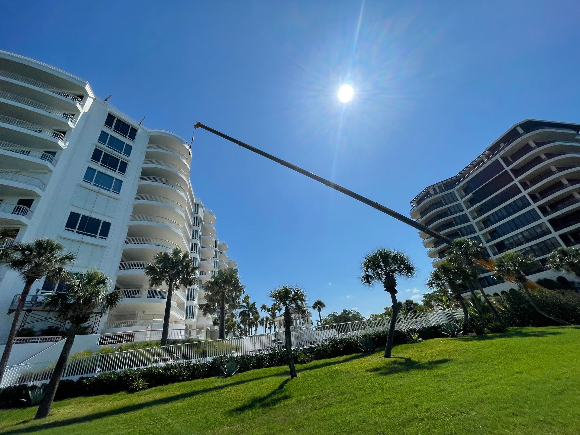 The sun is shining brightly behind a tall building