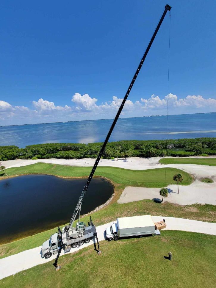 An aerial view of a truck with a crane attached to it.