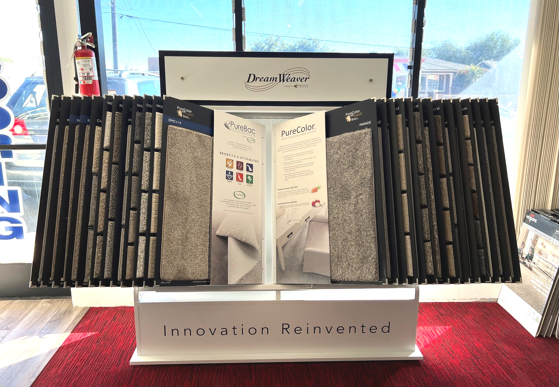 A display rack filled with various carpet samples, branded 