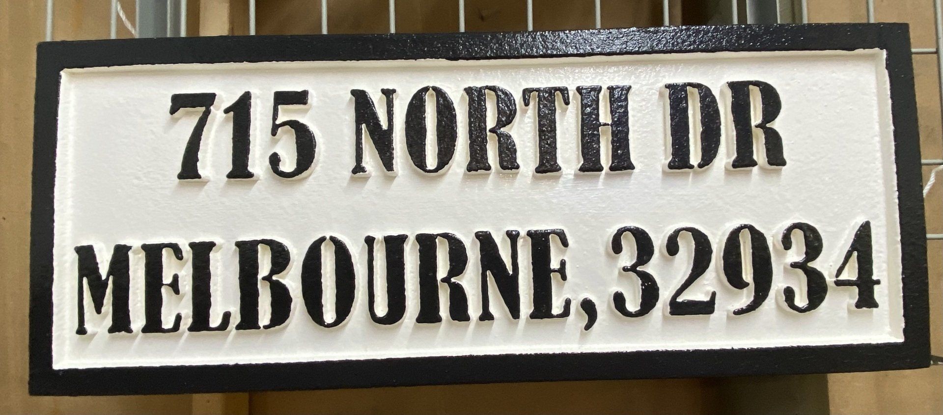 White address sign reading 715 North Dr, Melbourne, 32934