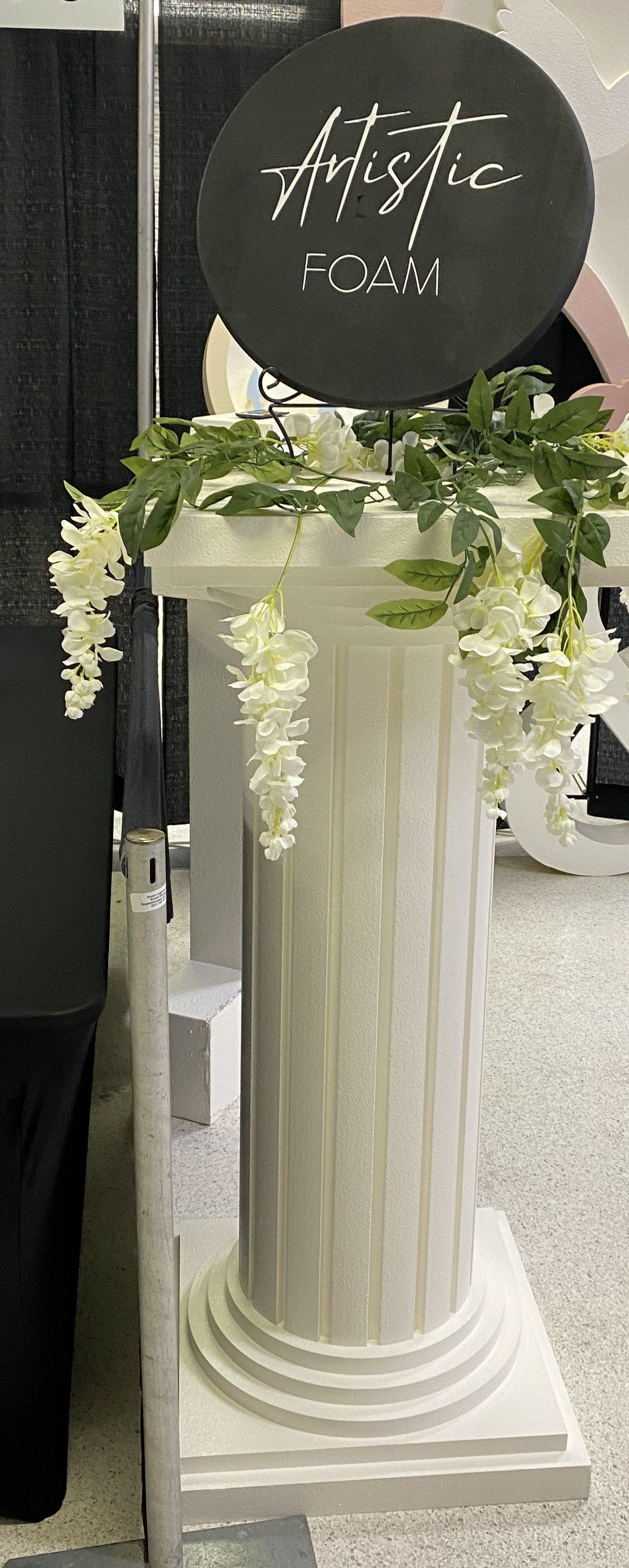 White decorative pedestal with greenery