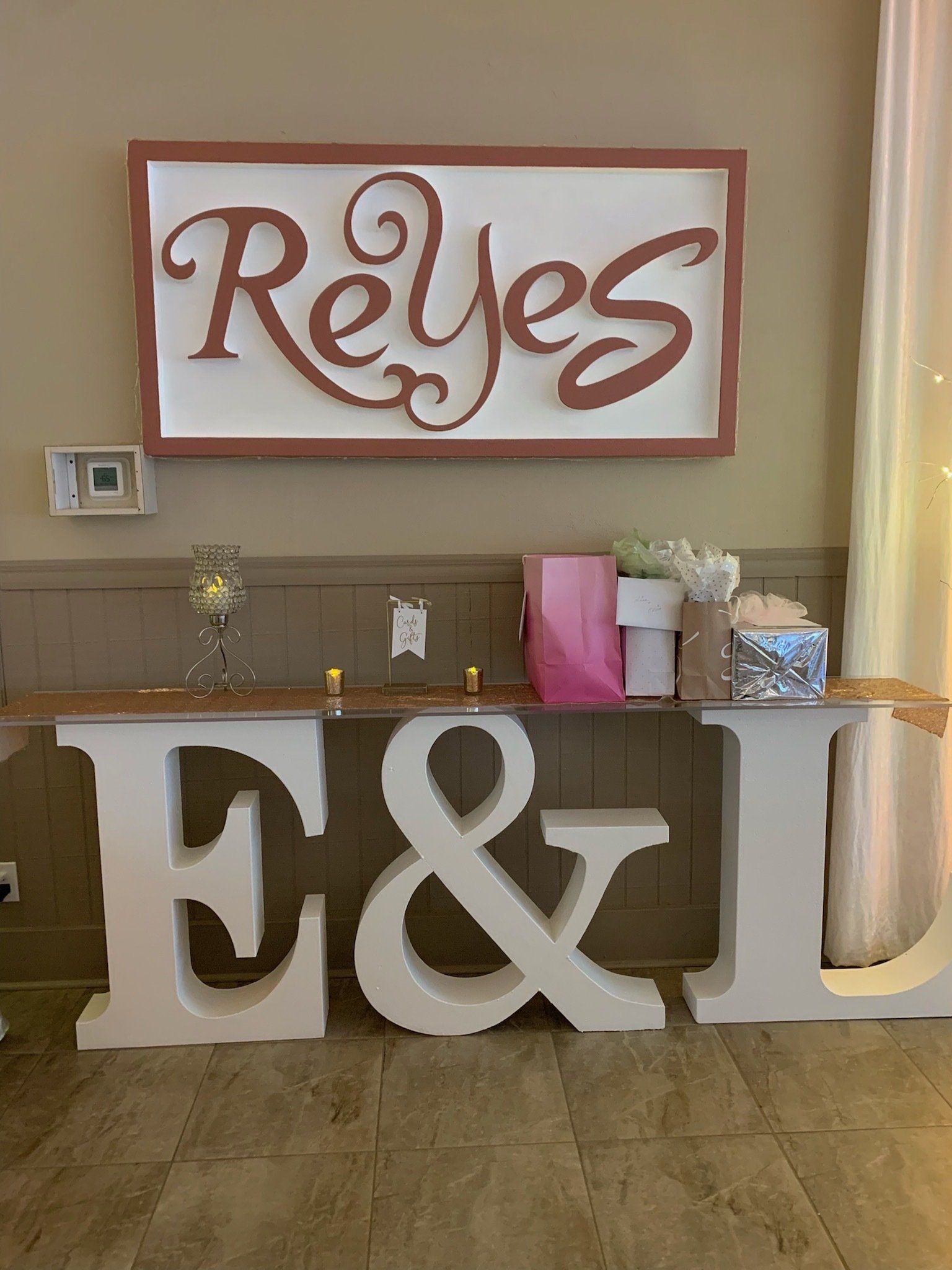 Decorated table with large gold letters for E & L and a Reyes sign above it
