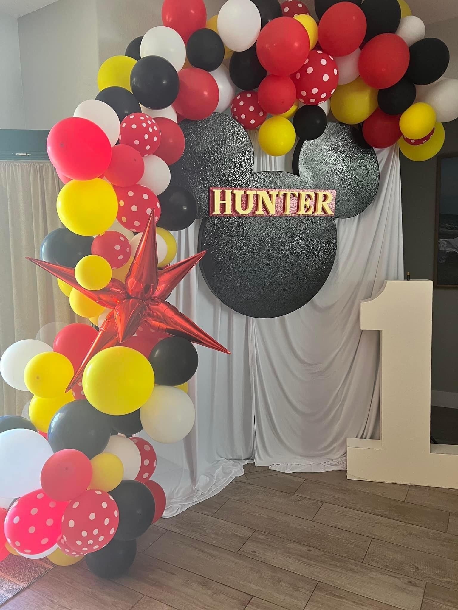 Black, red, and yellow balloon arch for Hunter's 1st birthday