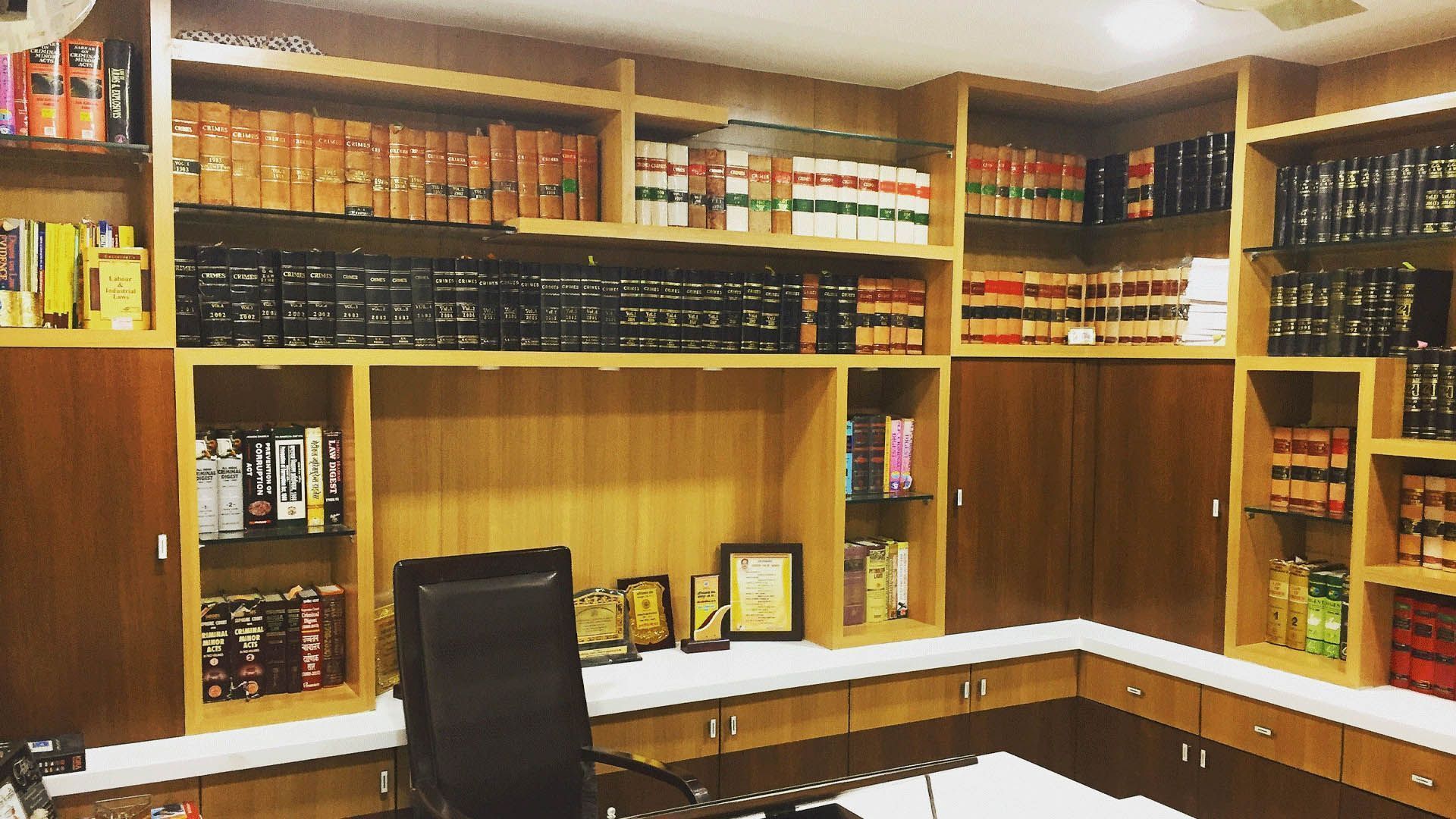 An office with wooden bookshelves filled with law books.