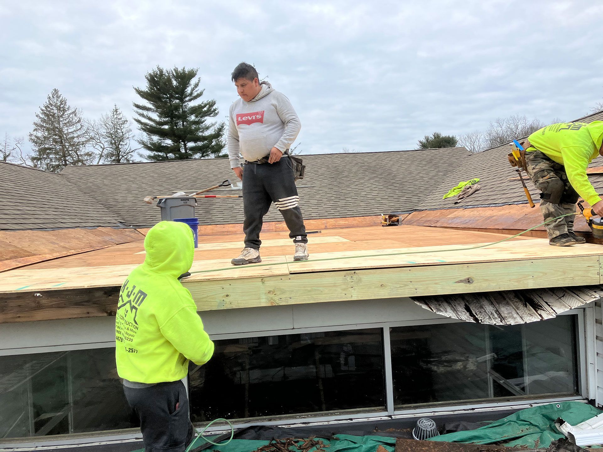 three men working on the roof