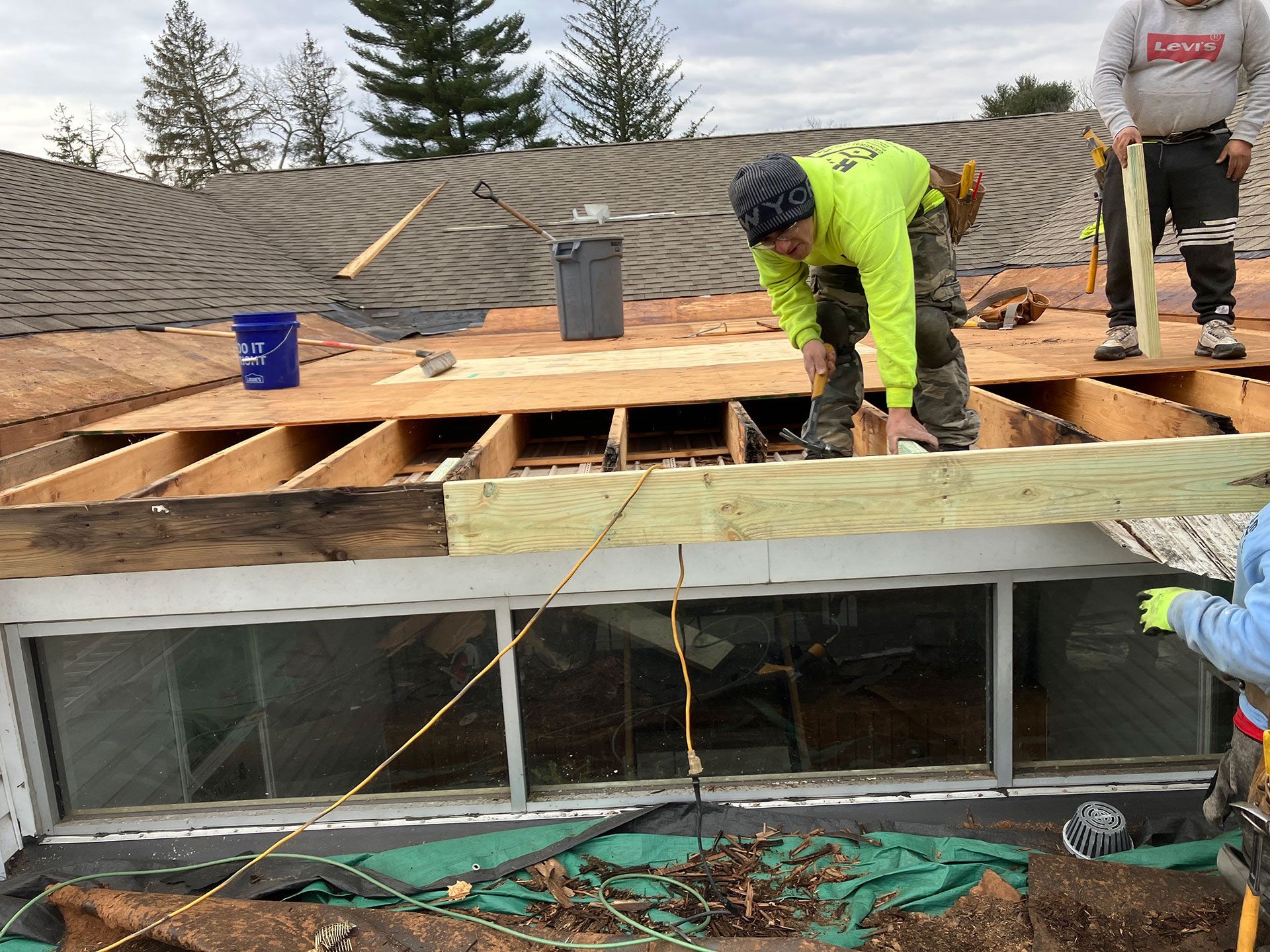 men replacing rotten wood