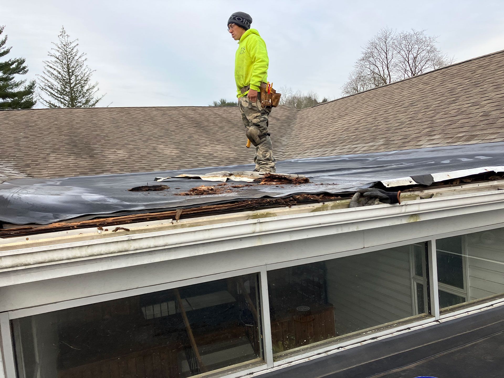 man in neon hoodie standing on the roof