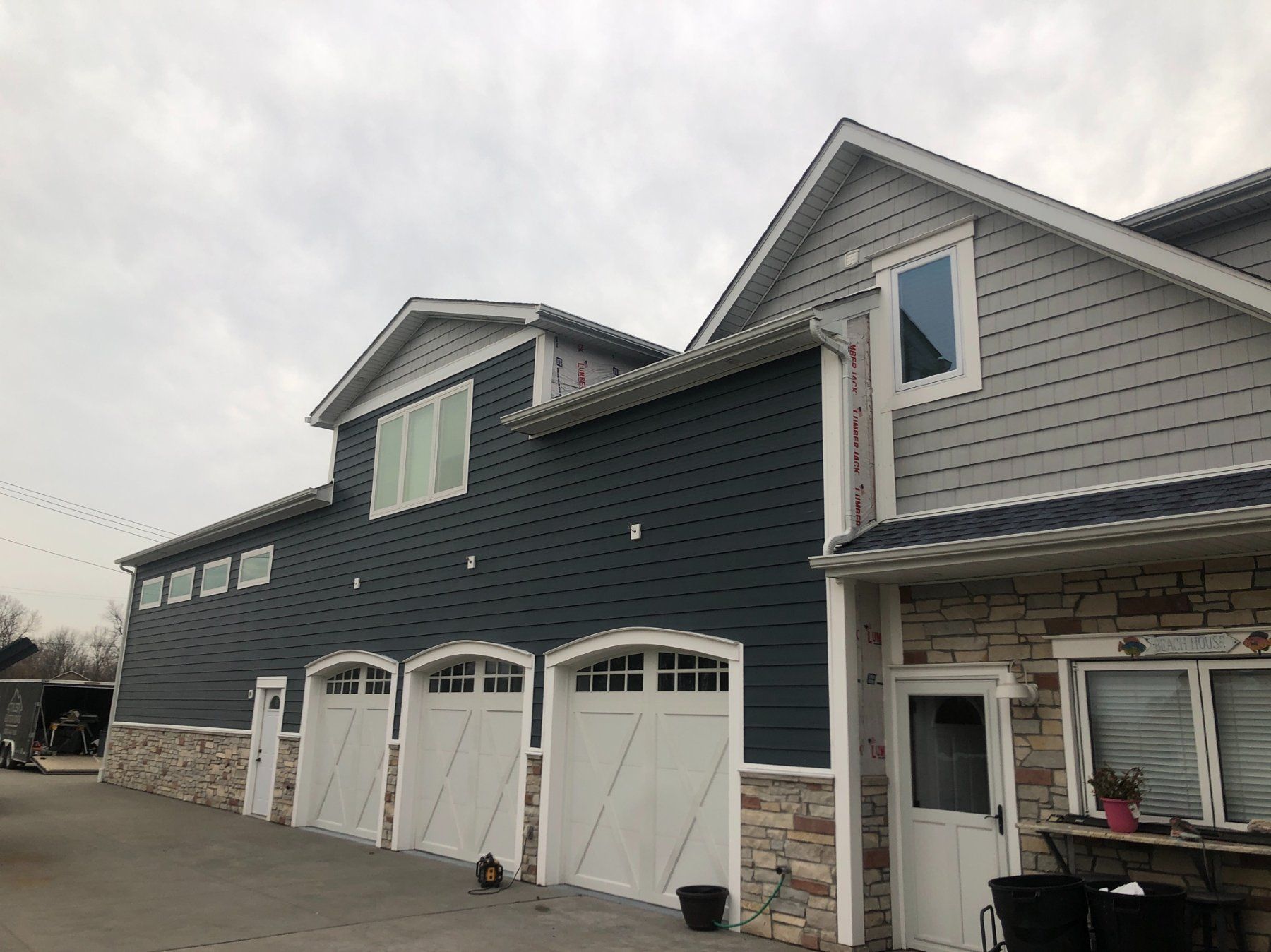 A large house with a lot of garage doors and windows.