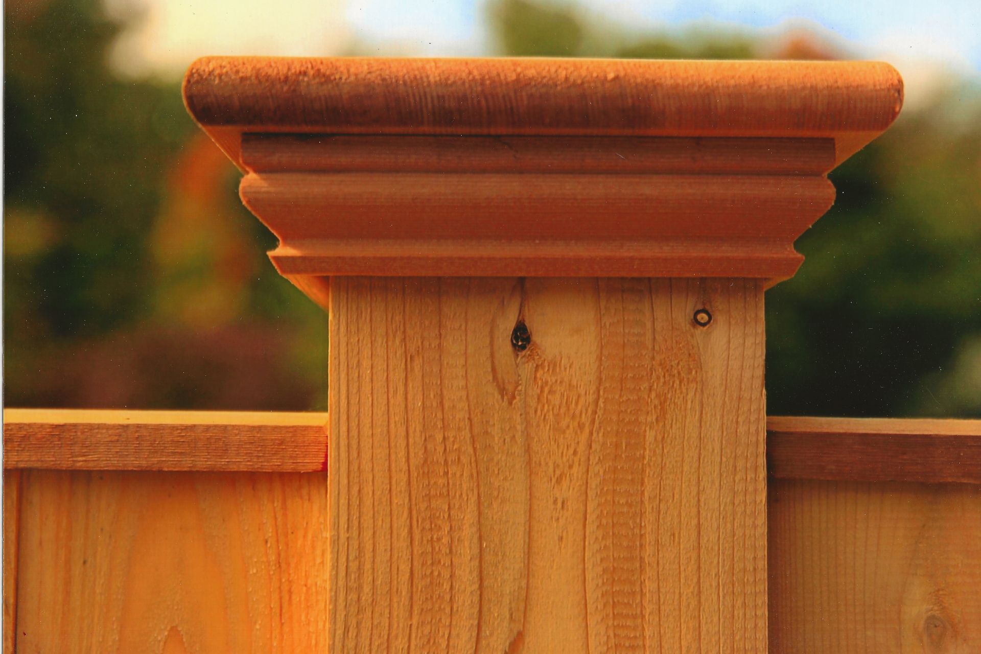 A close up of a wooden post on a wooden fence.