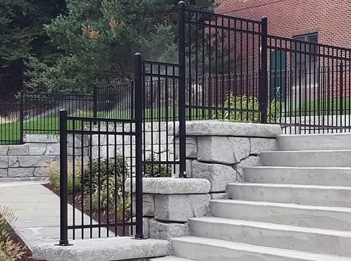 A black fence surrounds a set of stairs