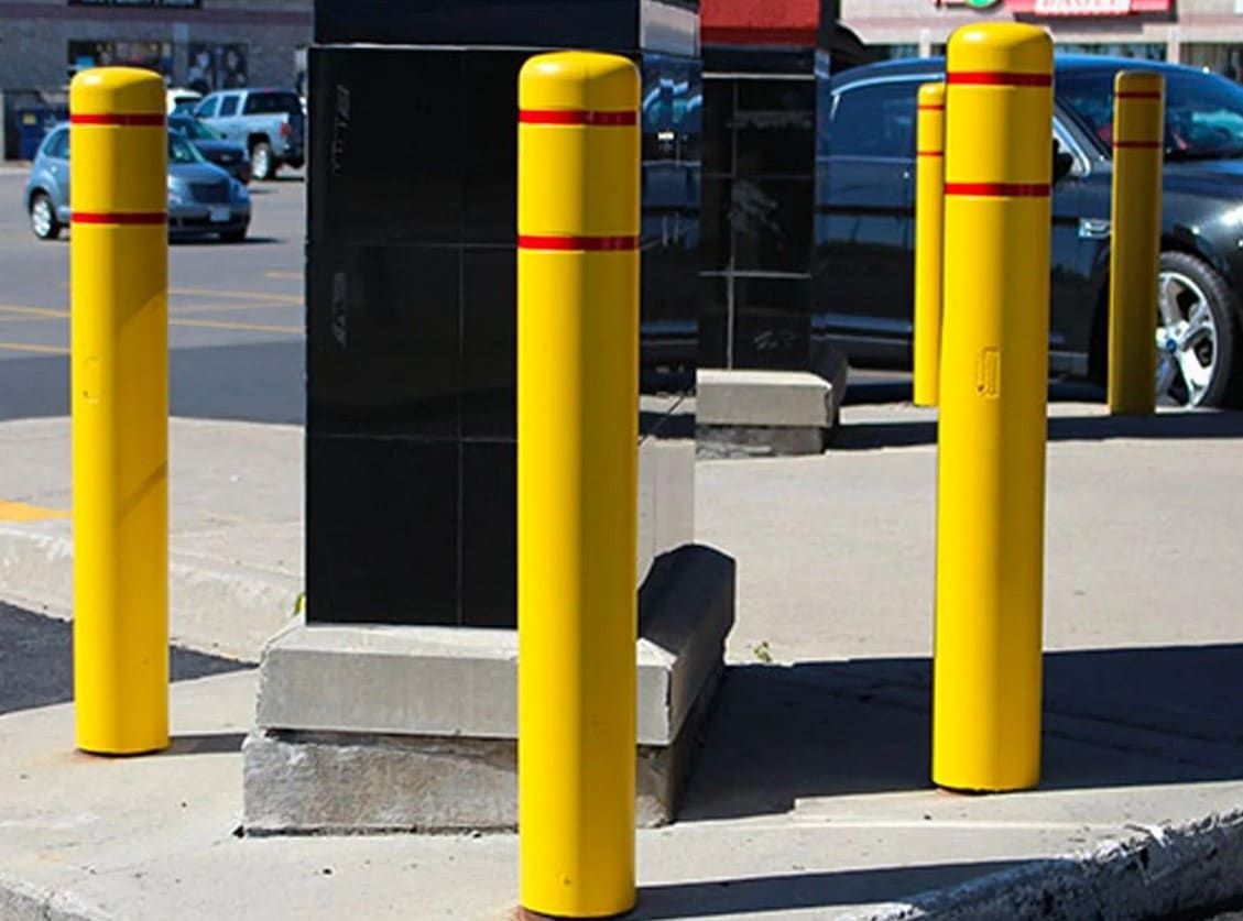 A row of yellow poles with red stripes on them