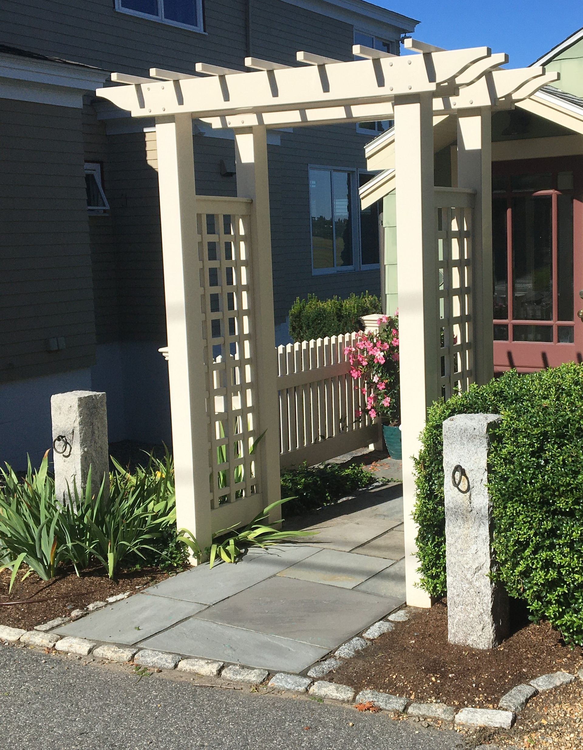 A house with a pergola and a walkway leading to it