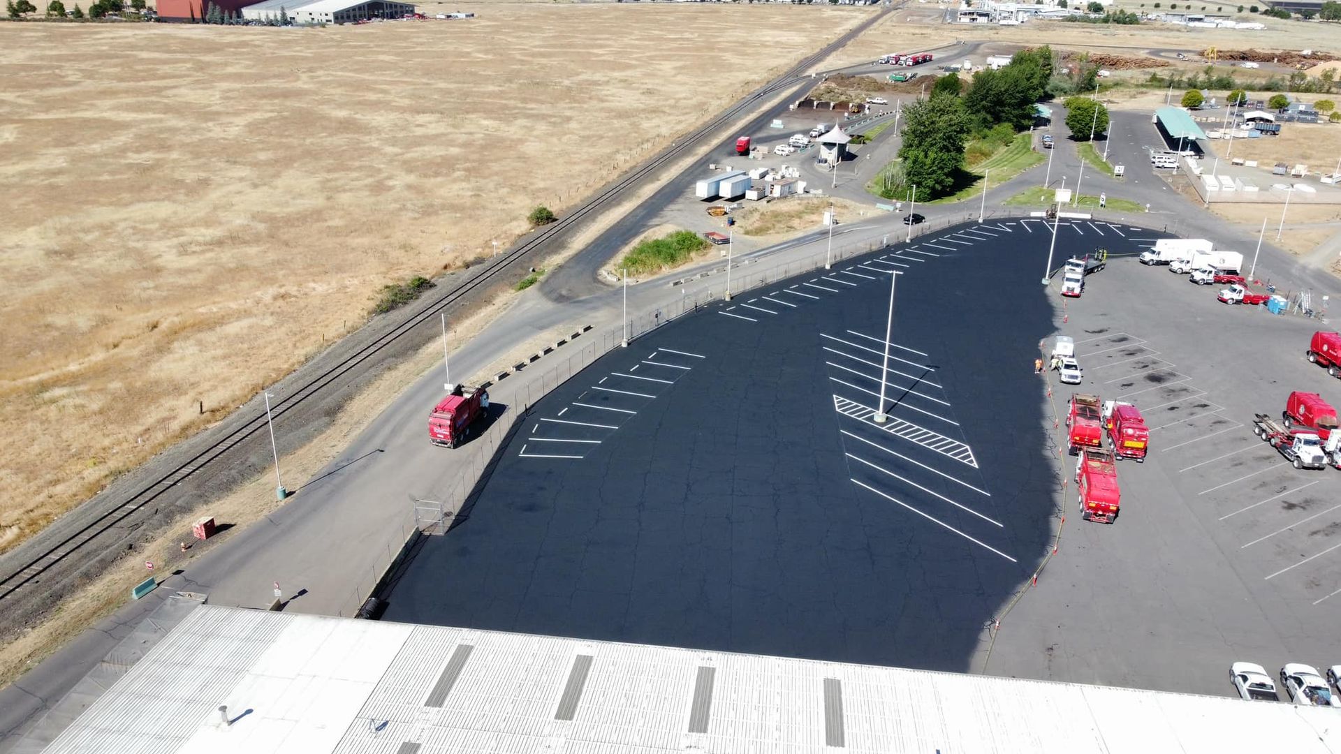 An aerial view of a parking lot with trucks parked in it