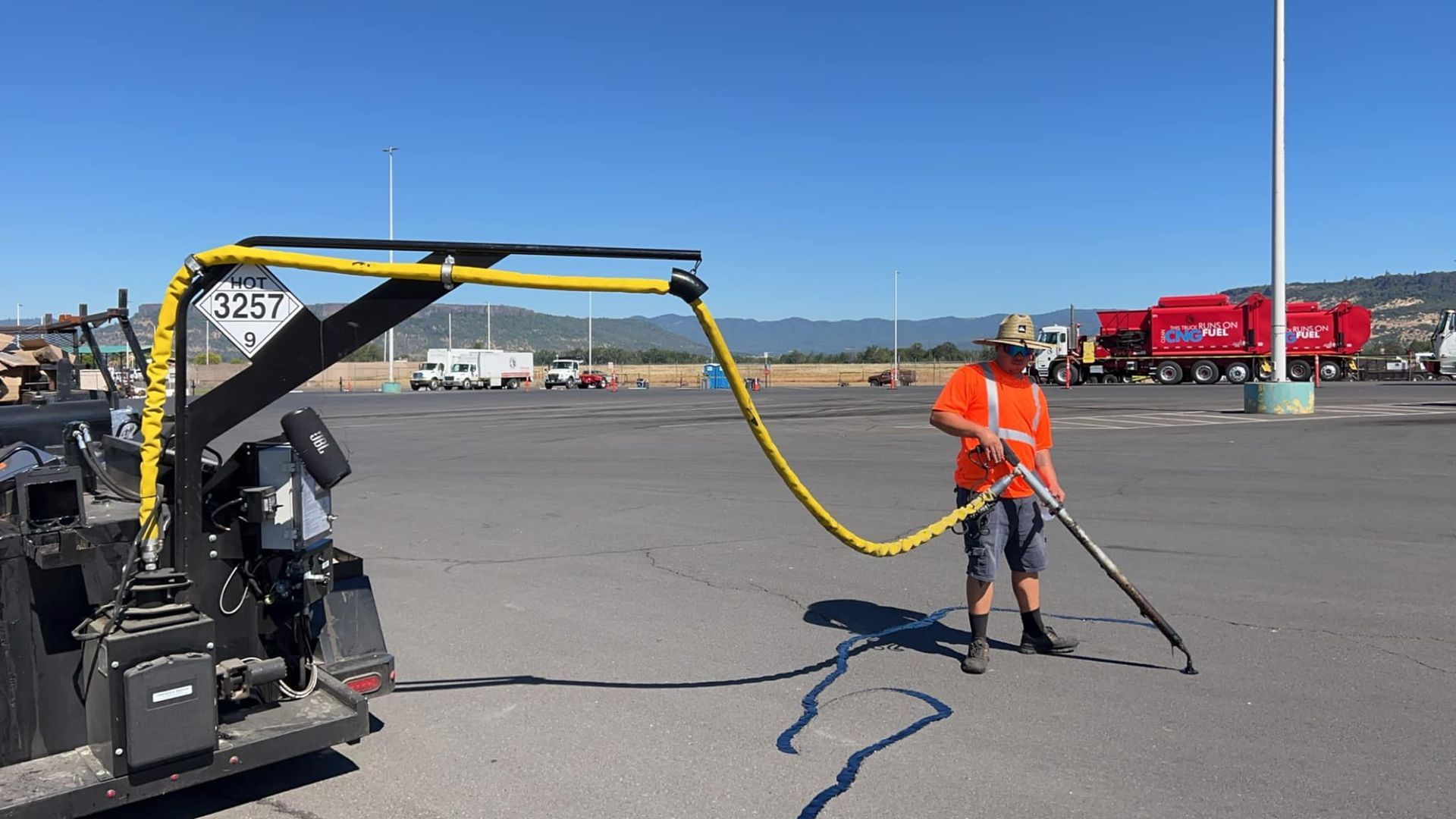 A man is using a vacuum cleaner to clean a parking lot.