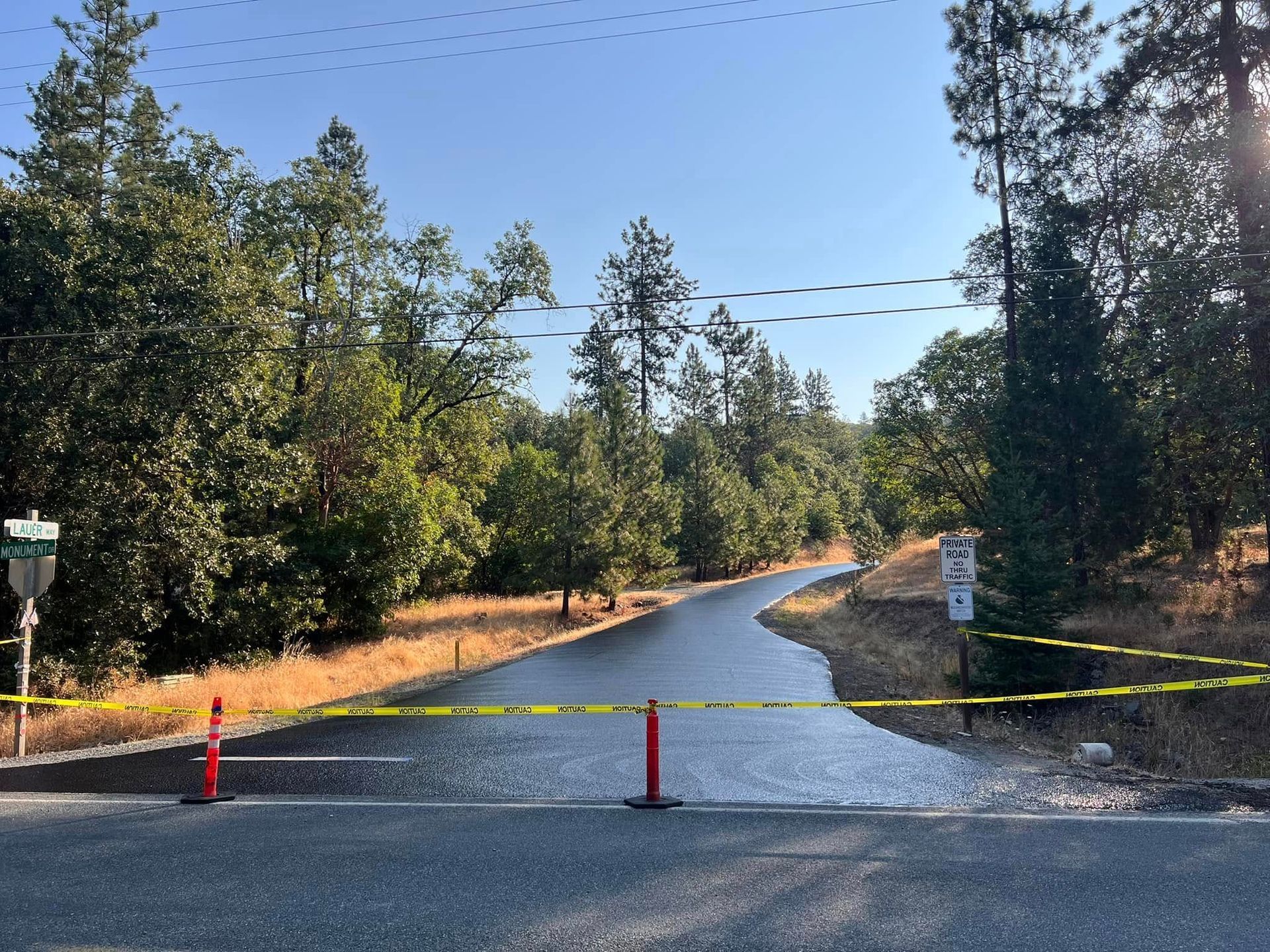 A road with a yellow tape barrier on the side of it